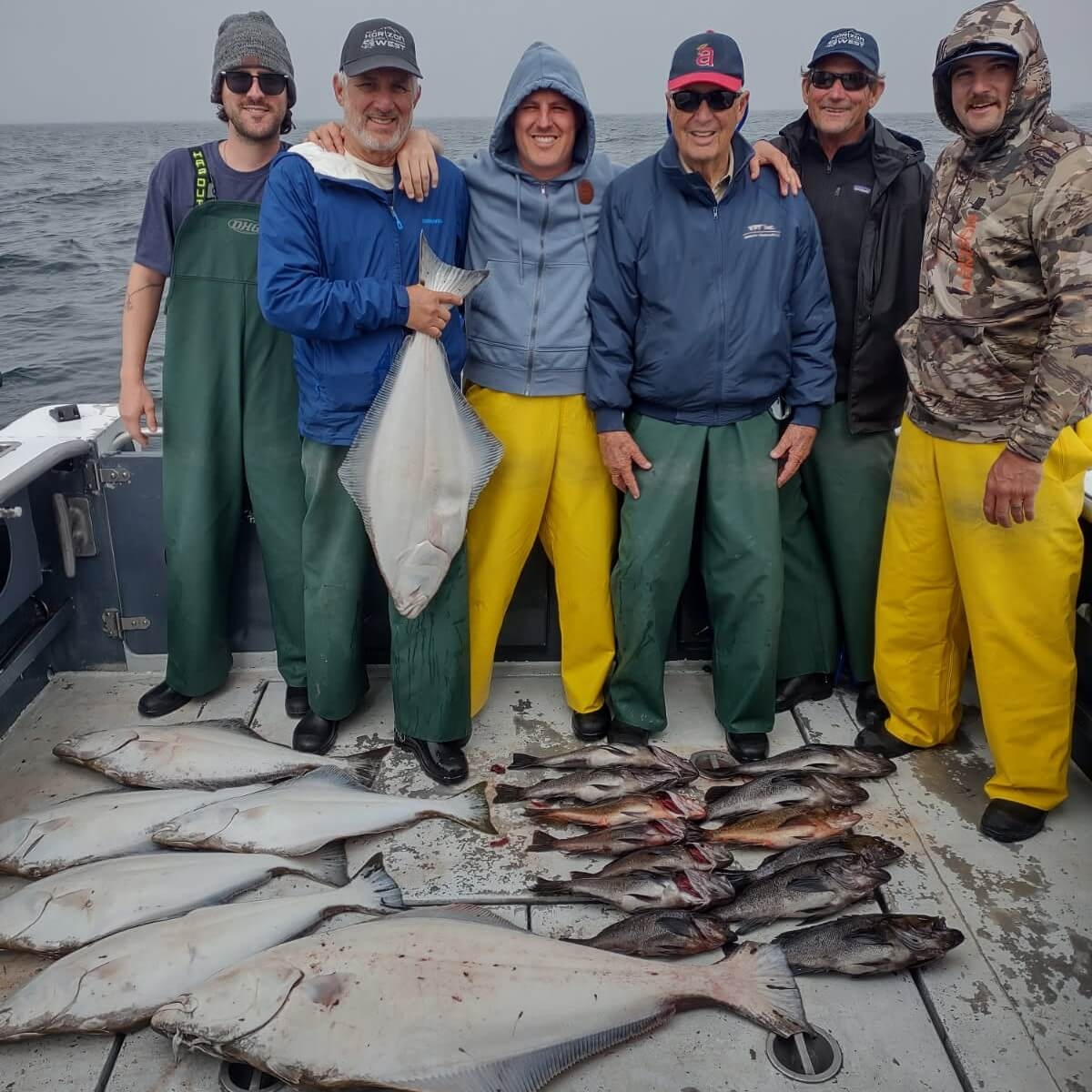 Top-Tier Guiding & Fish Care Happy group of fishermen with a great catch of halibut and rockfish in Sitka, Alaska with Horizon West Fishing Adventures